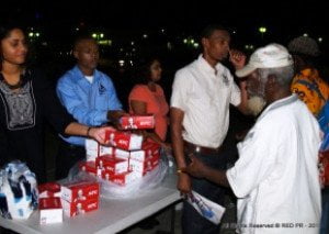 (L-R) Reynette Royer of Street Lamp Ministry and Kemar Saffrey from the Barbados Vagrants and Homeless Society sharing boxes of KFC’s finger lickin’ good chicken